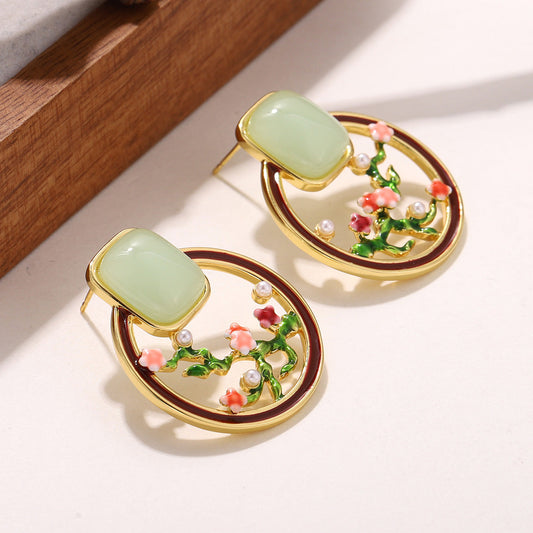 Closeup of Blossom Garden Earrings – green stone and gold-plated floral design
Orlaya Jewellery