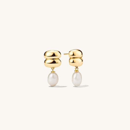 Minimal gold drop earrings with luminous pearl accents on a white background