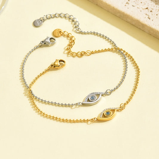 Gold Evil Eye Bracelet featuring deep blue stone and crystal details