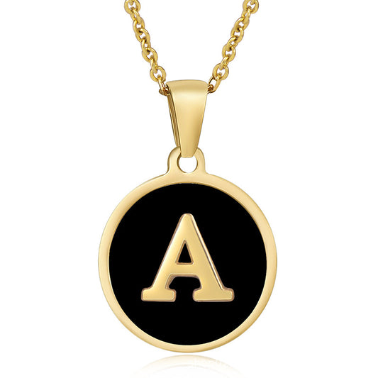 Gold initial pendant necklace with black enamel monogram