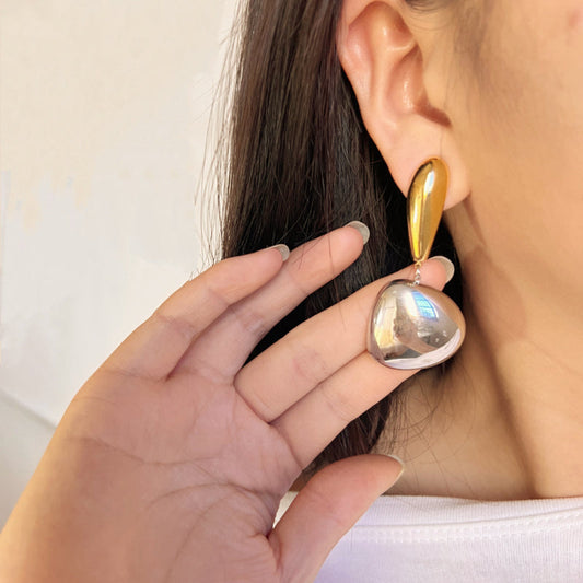 Mono Amour Drop Earrings – gold arc with silver sphere, modern two-tone statement jewellery model shot by Orlaya Jewellery