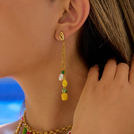 Model wearing gold pineapple and pearl dangle earrings with green bead accents – tropical summer vacation jewellery – Tropic Pop by Orlaya Jewellery.
