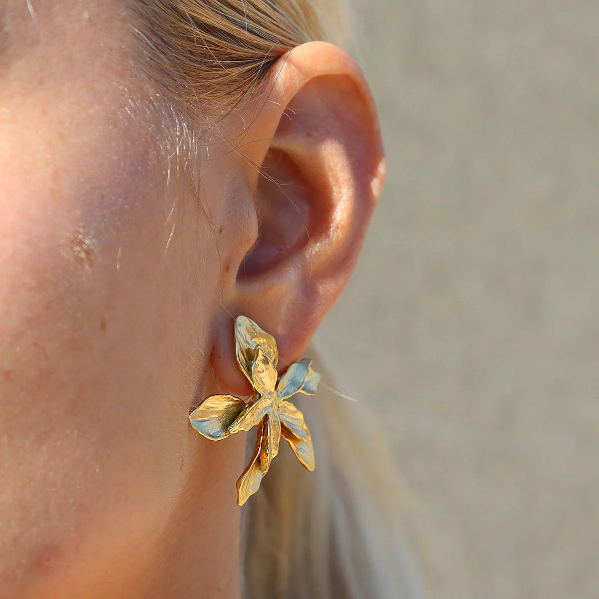 Close-up of Bloomform gold and silver floral earrings – 18K gold-plated flower design by Orlaya Jewellery