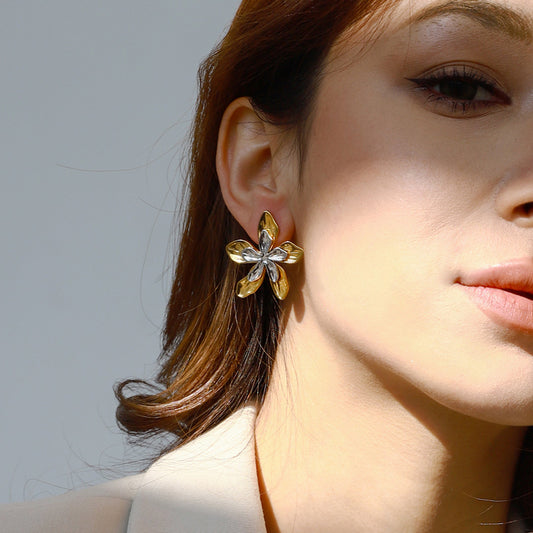 Model wearing Bloomform gold and silver floral earrings – statement floral jewellery for women