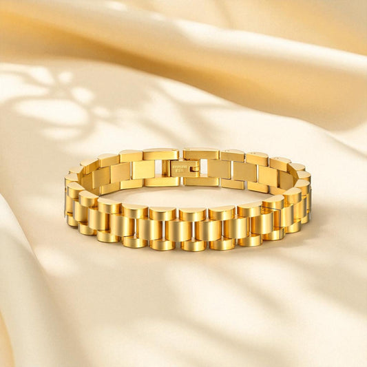Gold bracelet on a beige fabric background