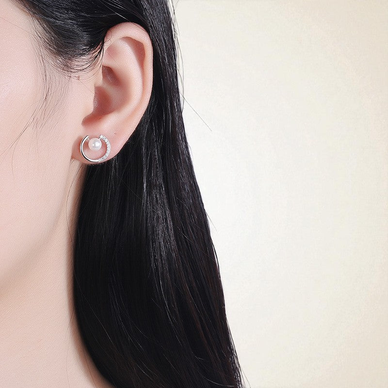 Model wearing Dayglow Silver Pearl Earrings in a golden arc with luminous pearls, S925 silver studs for timeless elegance and workday chic.