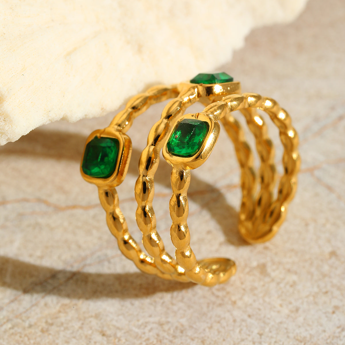 Maria’s Gold Ring with twisted gold bands and vivid green stones – Orlaya Jewellery