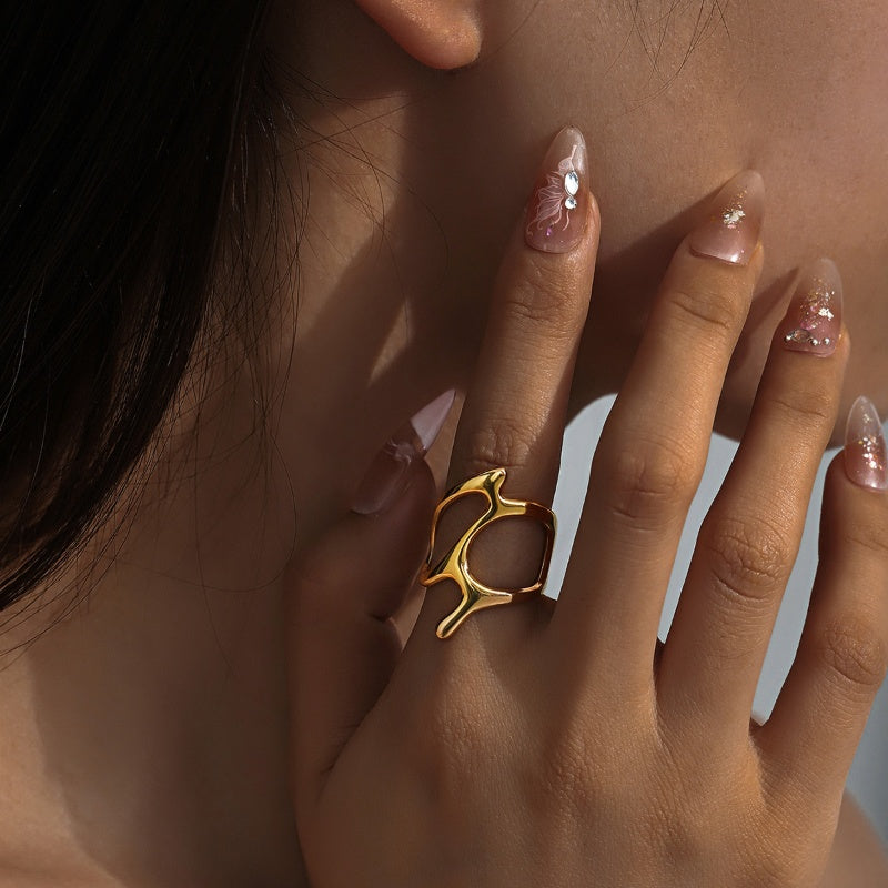 Modern gold ring with airy, artistic form on hand Orlaya Jewellery