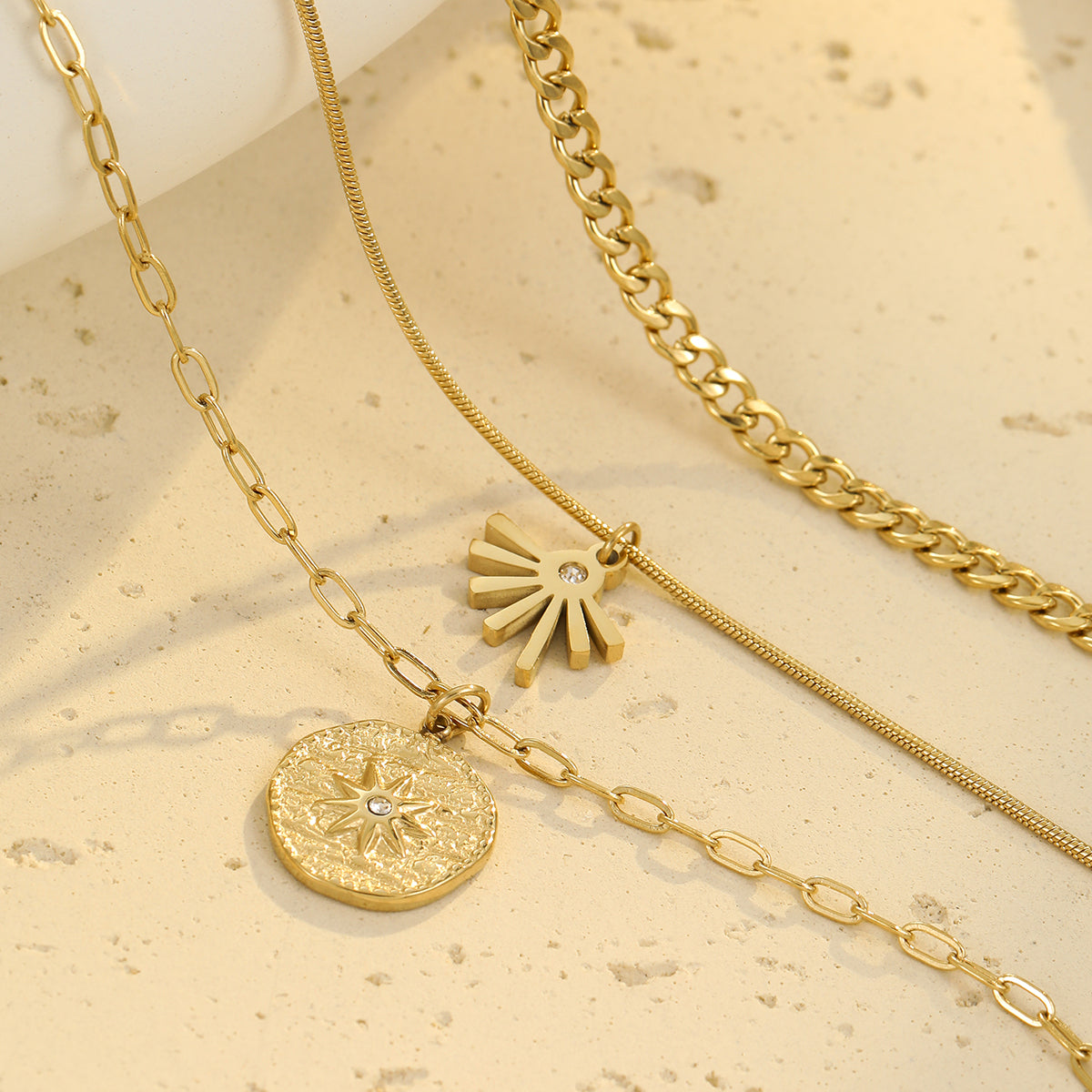 Sunburst medallion layered gold-tone necklace for women — close-up detail