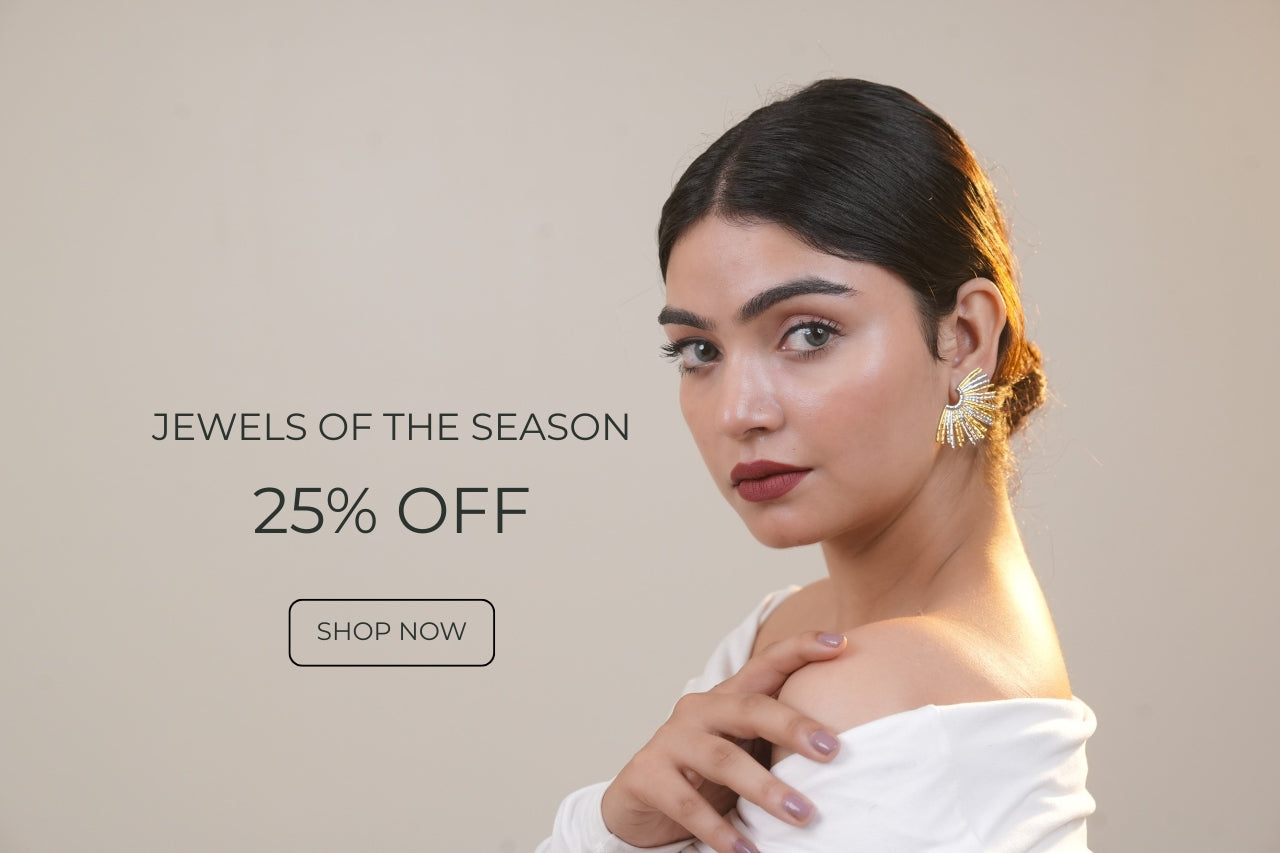 Model wearing gold statement earrings by Orlaya Jewellery — featuring earrings, necklaces, rings and bracelets