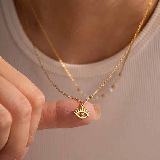Layered styling with a gold evil eye minimal necklace — Orlaya Jewellery