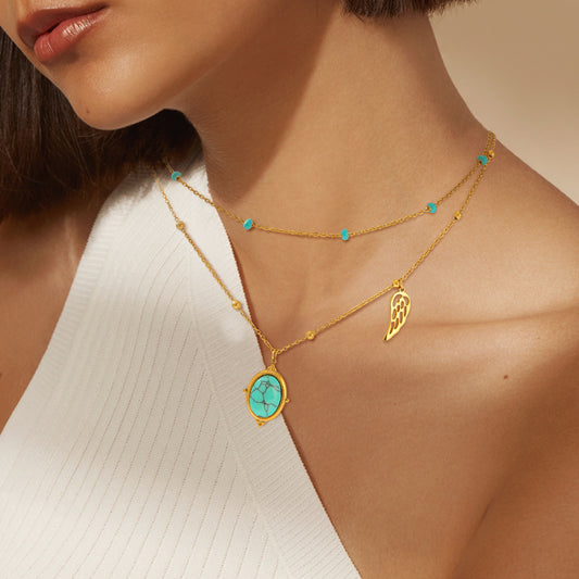 Wings of Blue Necklace — turquoise and gold layered necklace with wing charm by Orlaya Jewellery